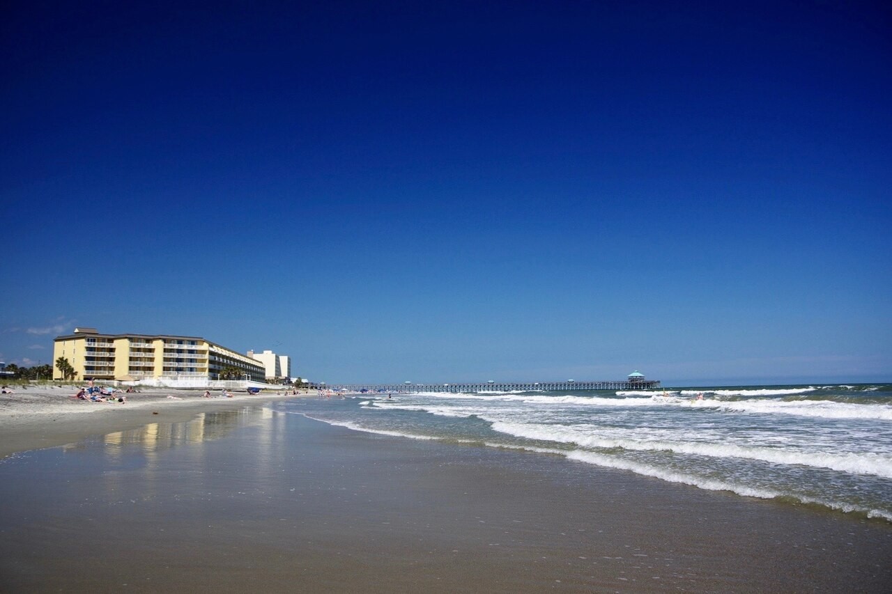 Municipal Folly Beach near the pier, looking northeast; photographed May 2018. The historical pier shown was subsequently replaced.