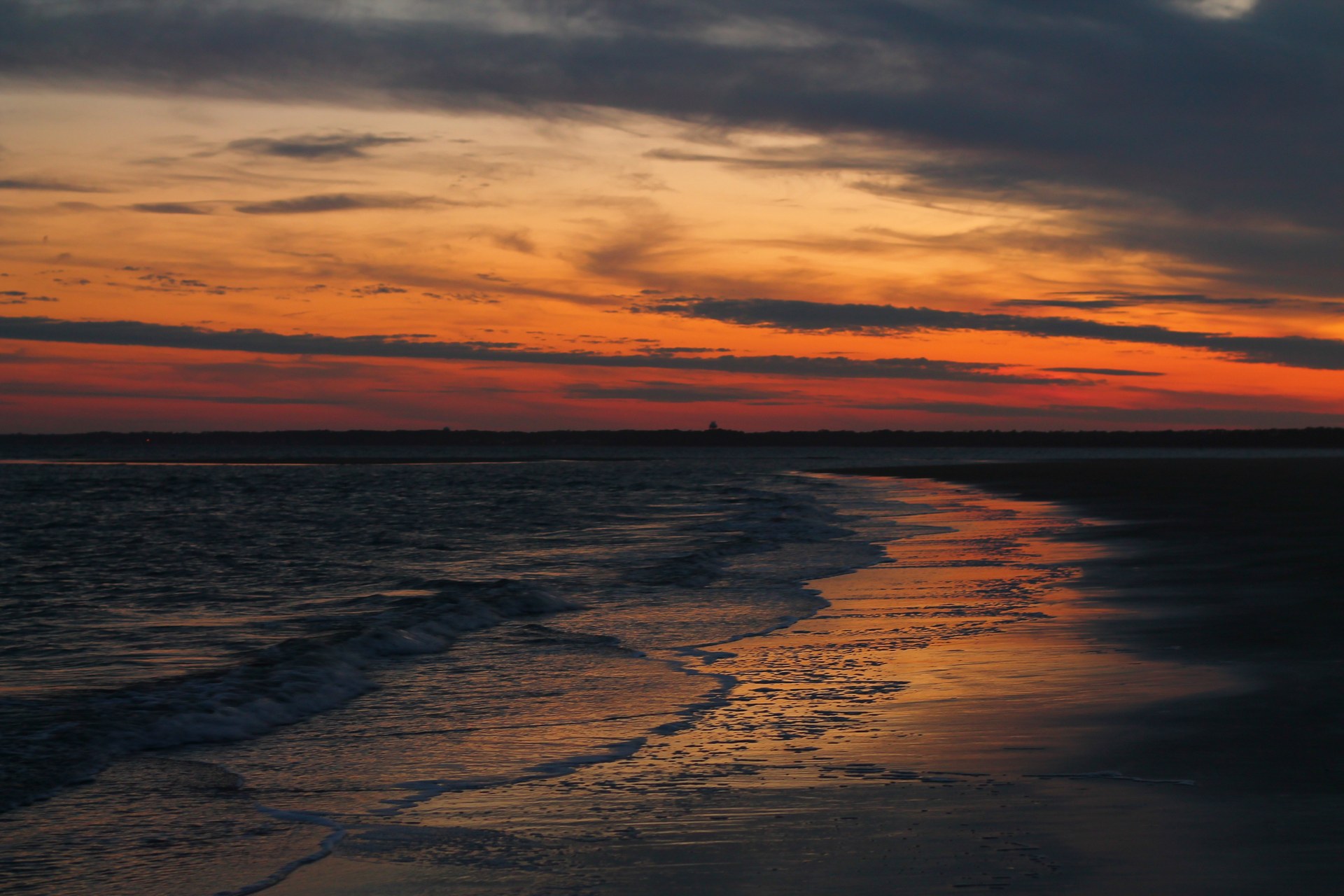 Warm sunset colors reflect in the wet sand and surf at East Beach on St. Simons Island Photograph: formulanone · CC BY-SA 2.0. Historical view; current conditions may differ.